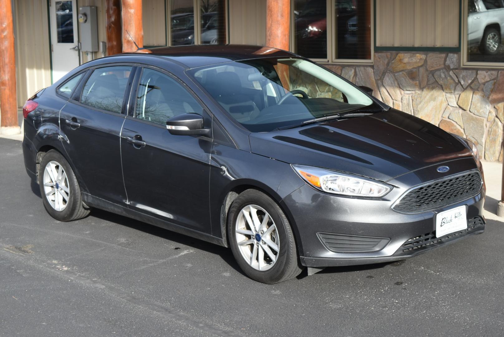 2016 Gray /Black Ford Focus SE (1FADP3F26GL) with an 2.0L I-4 GDI TI-VCT FLEX FUEL engine, 6-Speed Powershift Automatic transmission, located at 1600 E Hwy 44, Rapid City, SD, 57703, (605) 716-7878, 44.070232, -103.171410 - Photo#0